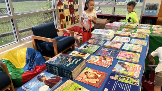 Kids looking at books.