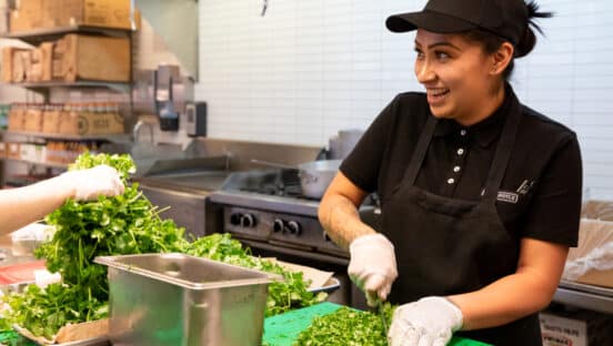 Chipotle employee working in the kitchen.