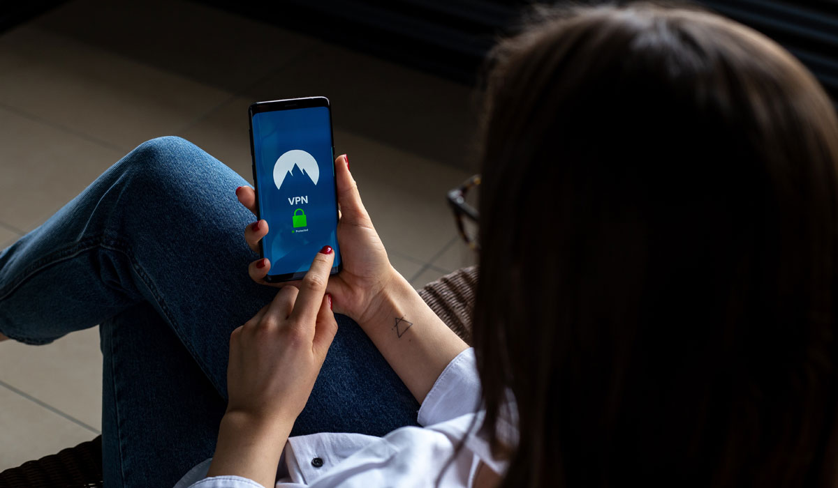 A Woman Holding A Smart Phone With A Lock Screen