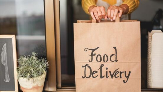 Food delivery bag held out a window.