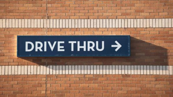 Drive-Thru sign on a brick wall.