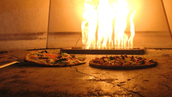 Fired Pie pizzas in an oven.