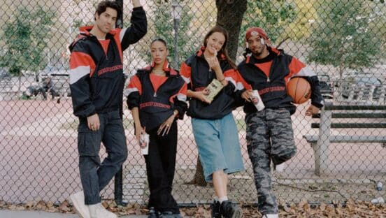 Four people posing in Jimmy John's Starter jackets.