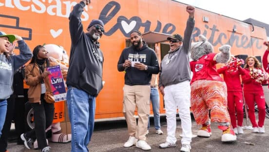 NFL player Cam Jordan with a Little Caesars truck.