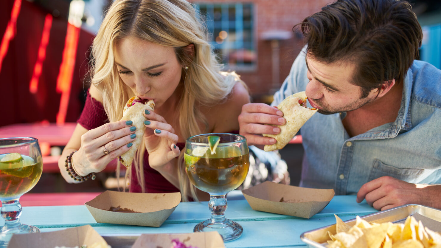 couple eating street tacos at outdoor mexican restaurant