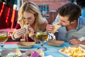 couple eating street tacos at outdoor mexican restaurant