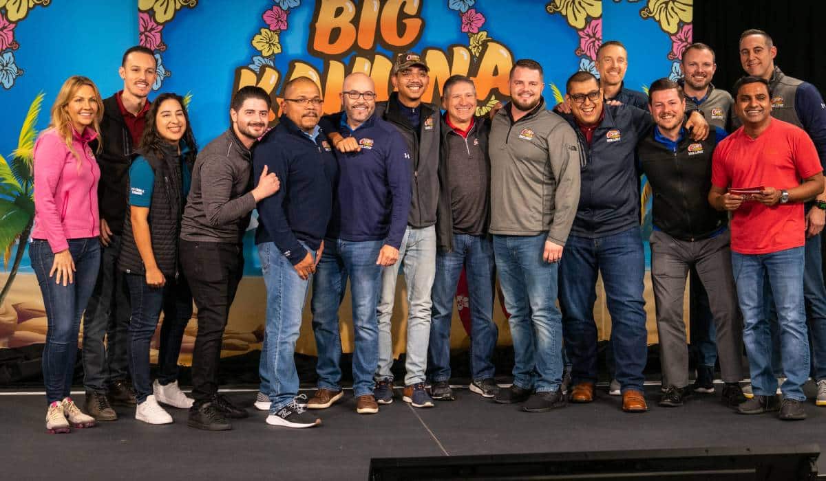 Raising Cane's General Managers Stand On Stage To Get An Award