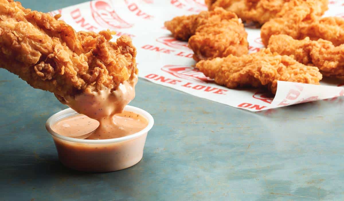 Raising Cane's Chicken Finger Dipped In Sauce