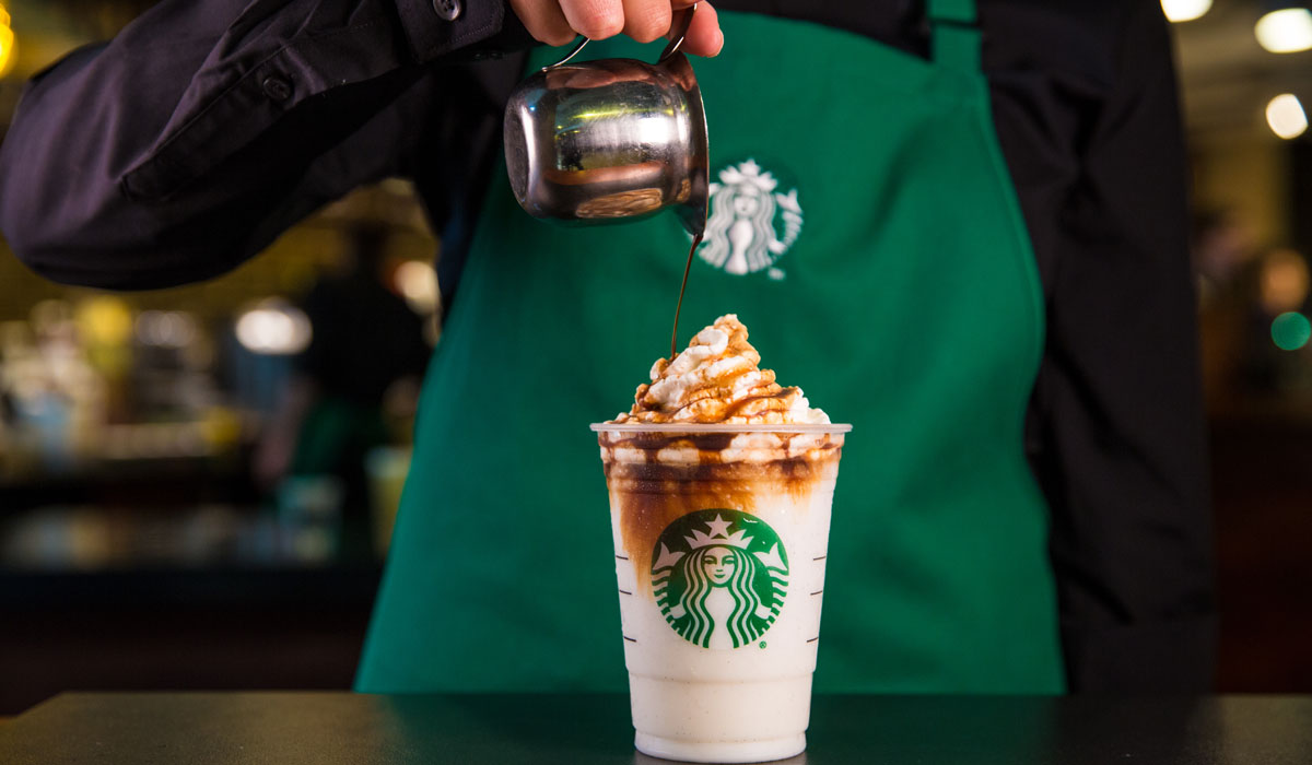 A Starbucks Barista Pours A Shot Of Espresso Into A Drink