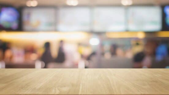 Restaurant table in front of blurred background.