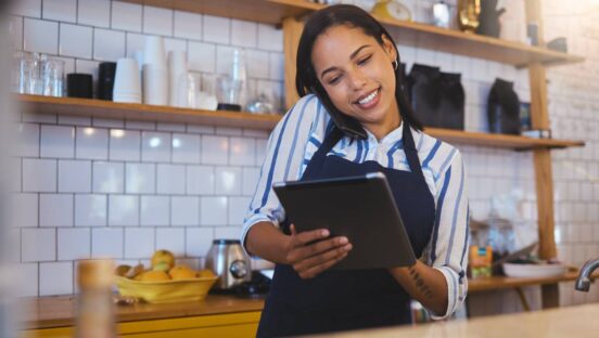 Restaurant worker on tablet, phone call and making food payment.