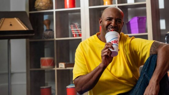 Man drinking a beverage from Sonic.