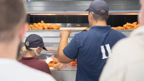 Staff Inside A Fast Food Restaurant Making Chicken