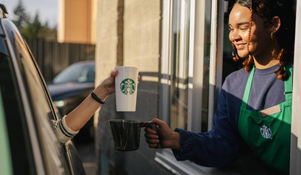 Starbucks personal cup being used at the drive-thru.