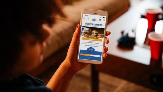 White Castle app in the hand of a customer.